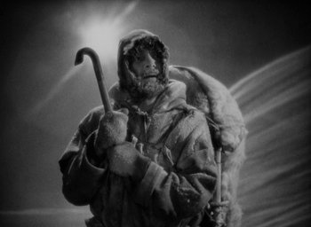 Movie still from “Lost Horizon” (1937), directed by Frank Capra – A man holding a walking stick in his hand; Medium shot, Low angle