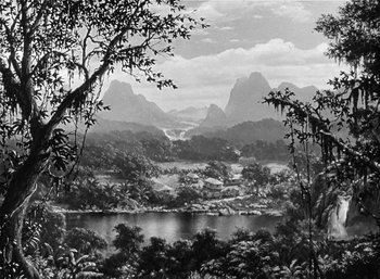 Movie still from “Mighty Joe Young” (1949), directed by Ernest B. Schoedsack – A black and white photo of mountains and a lake; Extreme Wide shot, High angle