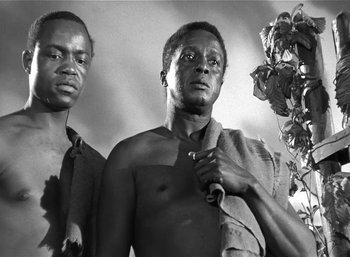 Movie still from “Mighty Joe Young” (1949), directed by Ernest B. Schoedsack – A black and white photo of two men standing next to each other; Close Up shot, Low angle