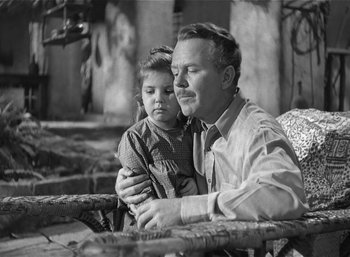 Movie still from “Mighty Joe Young” (1949), directed by Ernest B. Schoedsack – An old photo of a man and a little girl; Medium shot, High angle