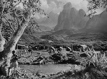 Movie still from “Mighty Joe Young” (1949), directed by Ernest B. Schoedsack – A black and white photo of a mountain scene; Extreme Wide shot, High angle