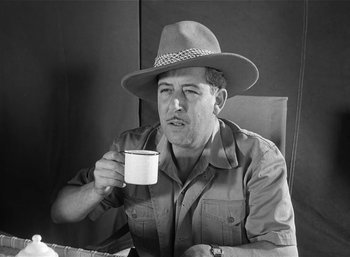 Movie still from “Mighty Joe Young” (1949), directed by Ernest B. Schoedsack – A black and white photo of a man holding a coffee mug; Close Up shot, Low angle