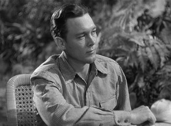 Movie still from “Mighty Joe Young” (1949), directed by Ernest B. Schoedsack – Black and white photograph of a man sitting outside; Close Up shot, Low angle