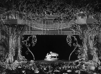 Movie still from “Mighty Joe Young” (1949), directed by Ernest B. Schoedsack – An old photo of a stage with a piano in the middle; Extreme Wide shot, High angle