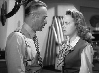 Movie still from “Mighty Joe Young” (1949), directed by Ernest B. Schoedsack – An old photo of a man and a young woman talking to each other; Close Up shot, Low angle