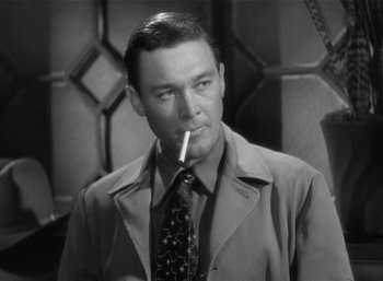 Movie still from “Mighty Joe Young” (1949), directed by Ernest B. Schoedsack – A man in a suit and tie smoking a cigarette; Close Up shot, Low angle