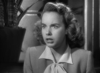 Movie still from “Mighty Joe Young” (1949), directed by Ernest B. Schoedsack – A black - and - white photo of a woman in a suit; Close Up shot, Low angle