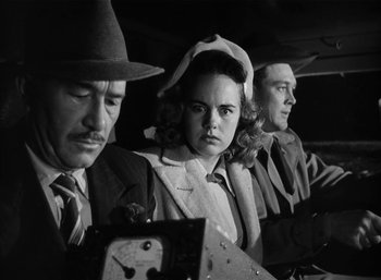 Movie still from “Mighty Joe Young” (1949), directed by Ernest B. Schoedsack – A group of people sitting next to each other in a room; Medium shot, Low angle