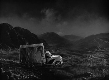 Movie still from “Mighty Joe Young” (1949), directed by Ernest B. Schoedsack – An old truck is parked in the middle of a field; Extreme Wide shot, High angle