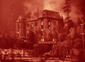 Movie still from “Mighty Joe Young” (1949), directed by Ernest B. Schoedsack – An image of an old building that is on fire; Extreme Wide shot, High angle