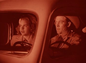 Movie still from “Mighty Joe Young” (1949), directed by Ernest B. Schoedsack – A man and a woman in the driver's seat of a car; Medium shot, Low angle