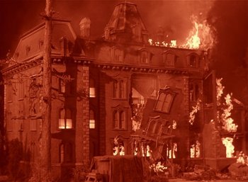 Movie still from “Mighty Joe Young” (1949), directed by Ernest B. Schoedsack – An old building is on fire with a lot of smoke; Extreme Wide shot, High angle