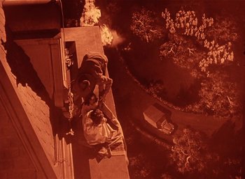 Movie still from “Mighty Joe Young” (1949), directed by Ernest B. Schoedsack – An aerial view of a person laying on a fire hydrant; Extreme Wide shot, Overhead angle
