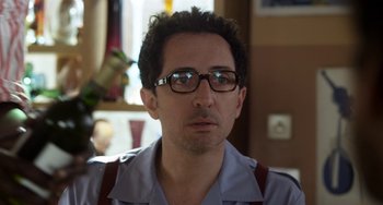 Movie still from “Mood Indigo” (2013), directed by Michel Gondry – A person wearing glasses; Close Up shot, Over the shoulder angle