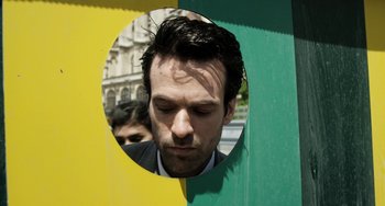 Movie still from “Mood Indigo” (2013), directed by Michel Gondry – A man in a suit looking into a mirror; Close Up shot, Overhead angle