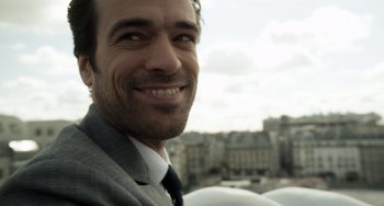 Movie still from “Mood Indigo” (2013), directed by Michel Gondry – A person wearing a suit and tie; Close Up shot, Low angle