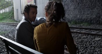 Movie still from “Mood Indigo” (2013), directed by Michel Gondry – A man and a woman sitting next to each other; Medium shot, Over the shoulder angle
