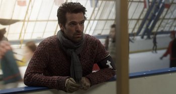 Movie still from “Mood Indigo” (2013), directed by Michel Gondry – A man wearing a scarf and gloves is leaning against a wall; Close Up shot, Over the shoulder angle