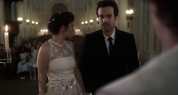 Movie still from “Mood Indigo” (2013), directed by Michel Gondry – A man and a woman standing next to each other; Medium shot, Over the shoulder angle