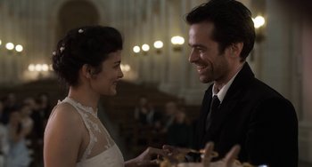 Movie still from “Mood Indigo” (2013), directed by Michel Gondry – A man and a woman smiling at each other in front of a crowd; Close Up shot, Over the shoulder angle