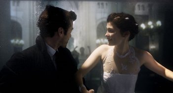 Movie still from “Mood Indigo” (2013), directed by Michel Gondry – A man and a woman holding each others hands; Medium shot, Overhead angle