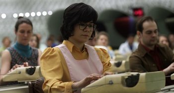Movie still from “Mood Indigo” (2013), directed by Michel Gondry – A woman in a yellow shirt is typing on a typewriter; Medium shot, Low angle