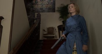 Movie still from “Mood Indigo” (2013), directed by Michel Gondry – A woman in a blue dress holding a gun; Medium shot, Low angle