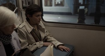 Movie still from “Mood Indigo” (2013), directed by Michel Gondry – A woman sitting on a train looking out the window; Medium shot, High angle