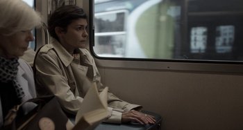 Movie still from “Mood Indigo” (2013), directed by Michel Gondry – A woman sitting on a train looking out the window; Medium shot, High angle