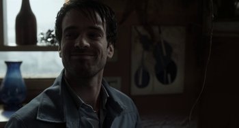 Movie still from “Mood Indigo” (2013), directed by Michel Gondry – A man smiling and looking to his left; Close Up shot, Low angle