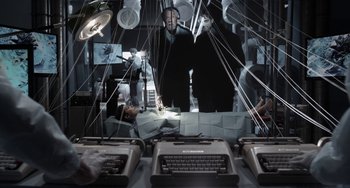 Movie still from “Mood Indigo” (2013), directed by Michel Gondry – A group of people standing in a room with wires hanging from the ceiling; Wide shot, Overhead angle