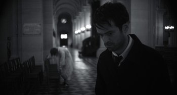 Movie still from “Mood Indigo” (2013), directed by Michel Gondry – A black and white photo of a man and a woman; Medium shot, Low angle
