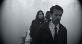 Movie still from “Mood Indigo” (2013), directed by Michel Gondry – A man and two women walking on a bridge; Medium shot, Over the shoulder angle