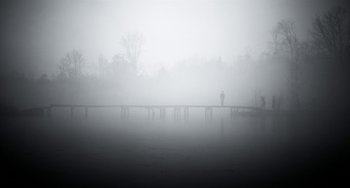 Movie still from “Mood Indigo” (2013), directed by Michel Gondry – A person standing on a pier in the fog; Extreme Wide shot, Low angle