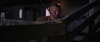 Movie still from “Nevada Smith” (1966), directed by Henry Hathaway – A man in a brown shirt is looking at a rope; Close Up shot, Low angle
