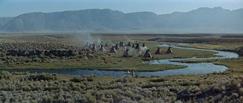 Movie still from “Nevada Smith” (1966), directed by Henry Hathaway – A group of people standing in a grassy field; Extreme Wide shot, High angle