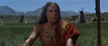 Movie still from “Nevada Smith” (1966), directed by Henry Hathaway – An older native american man in a red shirt; Close Up shot, Low angle