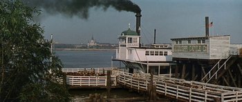 Movie still from “Nevada Smith” (1966), directed by Henry Hathaway – A large boat is in the water near a dock; Extreme Wide shot, Low angle