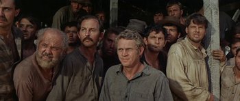 Movie still from “Nevada Smith” (1966), directed by Henry Hathaway – A group of men standing next to each other in front of a building; Medium shot, Low angle