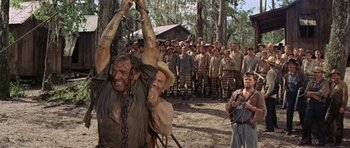 Movie still from “Nevada Smith” (1966), directed by Henry Hathaway – A group of men standing in front of one another; Wide shot, Low angle