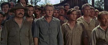 Movie still from “Nevada Smith” (1966), directed by Henry Hathaway – A group of men standing next to each other in a field; Medium shot, Low angle