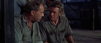 Movie still from “Nevada Smith” (1966), directed by Henry Hathaway – Two men are sitting next to each other; Close Up shot, Over the shoulder angle