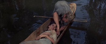 Movie still from “Nevada Smith” (1966), directed by Henry Hathaway – A man and a woman are in a boat in the water; Medium shot, High angle