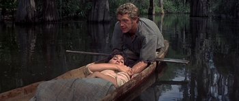 Movie still from “Nevada Smith” (1966), directed by Henry Hathaway – A man and a woman are in a boat in the water; Medium shot, High angle