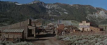 Movie still from “Nevada Smith” (1966), directed by Henry Hathaway – A group of people riding horses down a dirt road; Extreme Wide shot, Low angle