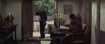 Movie still from “Nevada Smith” (1966), directed by Henry Hathaway – A man standing in front of an open window; Wide shot, Over the shoulder angle