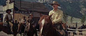 Movie still from “Nevada Smith” (1966), directed by Henry Hathaway – Two men on horses in front of a building; Medium shot, Low angle