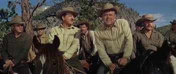 Movie still from “Nevada Smith” (1966), directed by Henry Hathaway – A group of men on horses in a field; Medium shot, Low angle