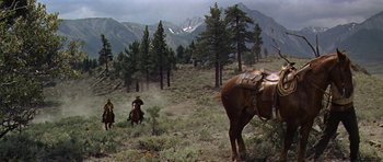 Movie still from “Nevada Smith” (1966), directed by Henry Hathaway – A group of people riding horses in a field; Extreme Wide shot, Low angle