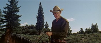 Movie still from “Nevada Smith” (1966), directed by Henry Hathaway – A man wearing a cowboy hat holding a lasso; Medium shot, Low angle